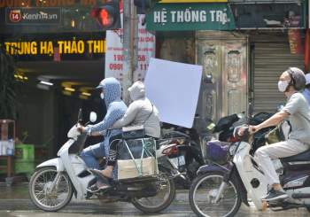 Nắng nóng đỉnh điểm từ đầu hè lên đến 40 độ C tại Hà Nội: Nhựa đường tan chảy, người dân dùng nước tưới đường giữa trưa - Ảnh 21.